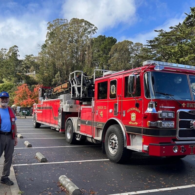 Firewise leader standing in front of a fire truck