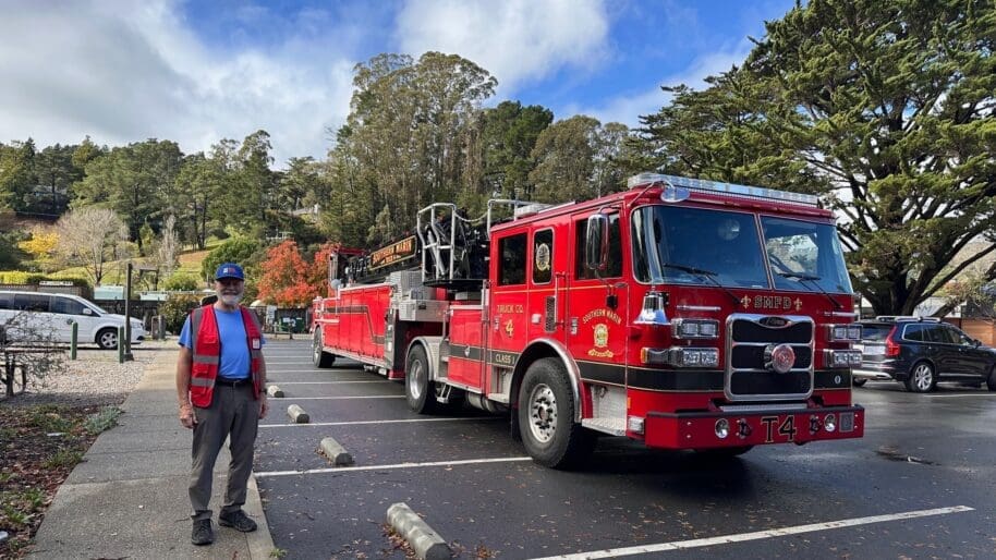 Firewise leader standing in front of a fire truck