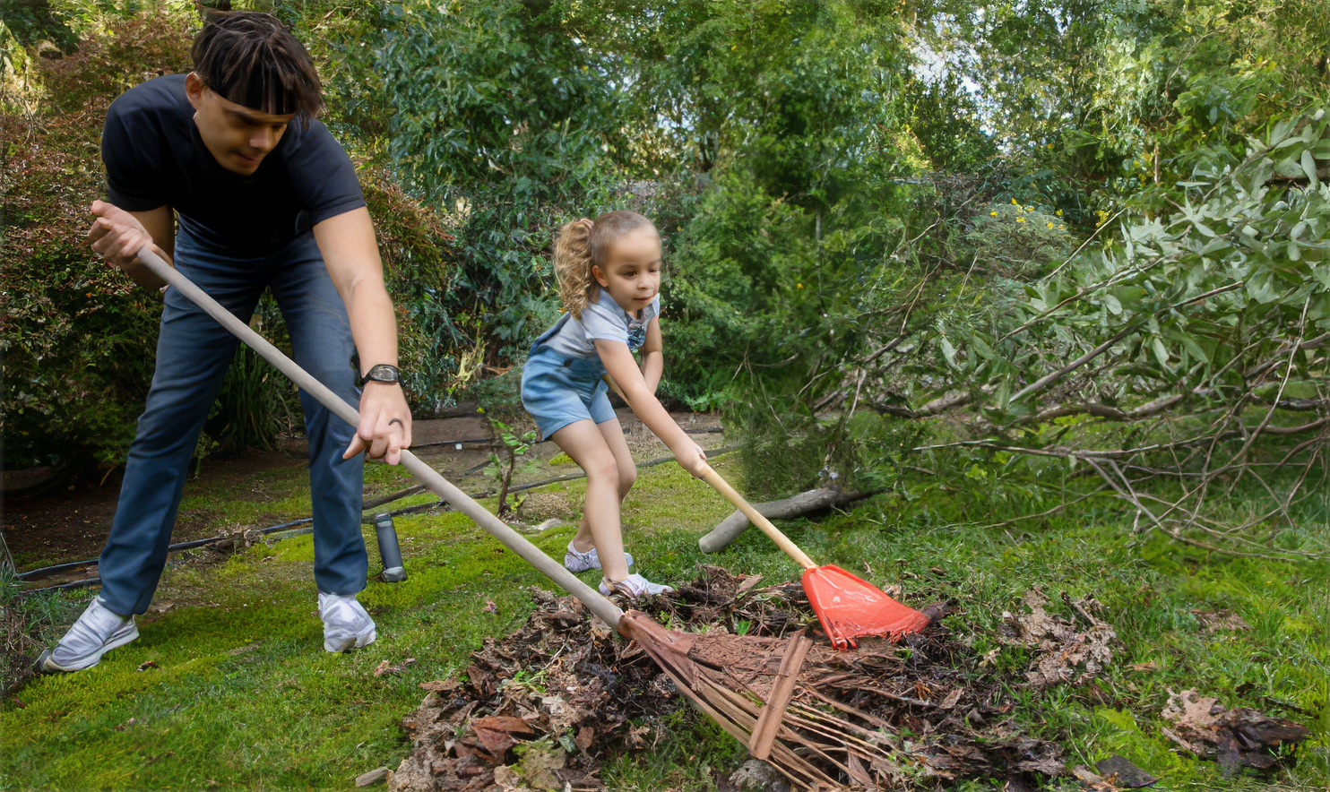 happy family raking leaves in the yard