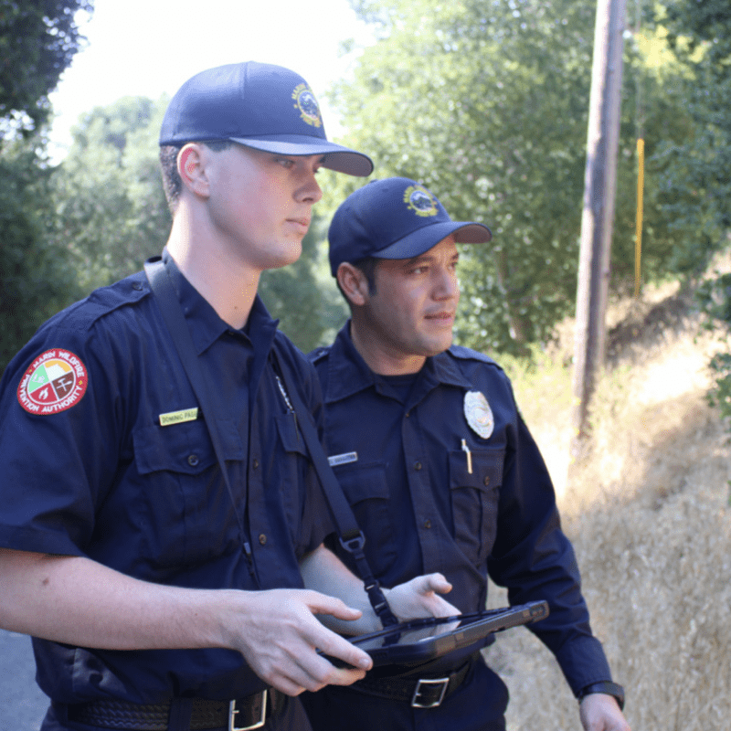 Two home inspectors evaluating a home's risk to wildfire