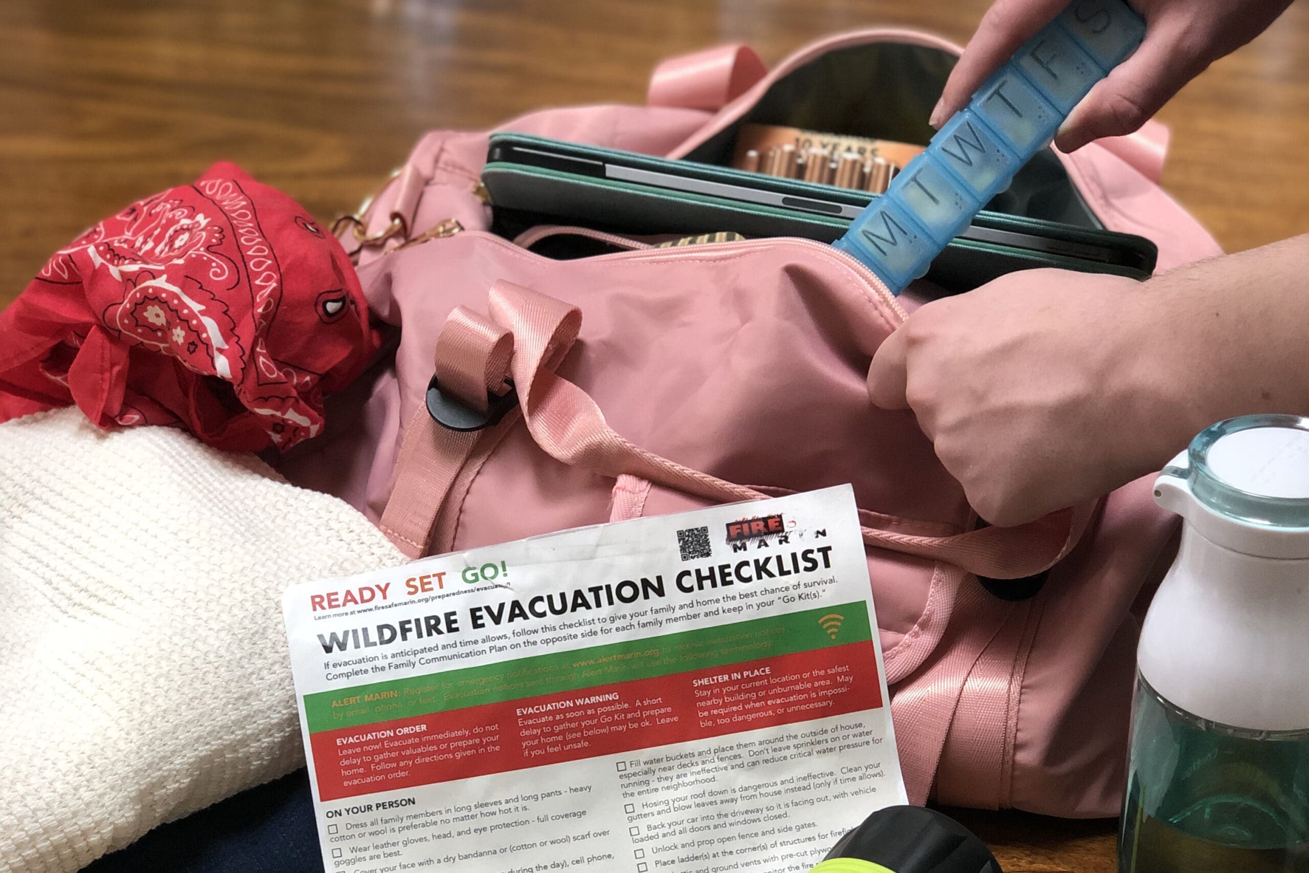 someone packing an evacuation bag