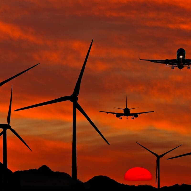 plane flying in orange sky