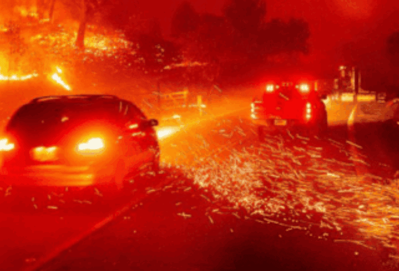 road on fire with car driving through it