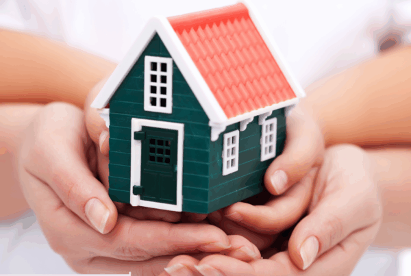 hands holding a toy house