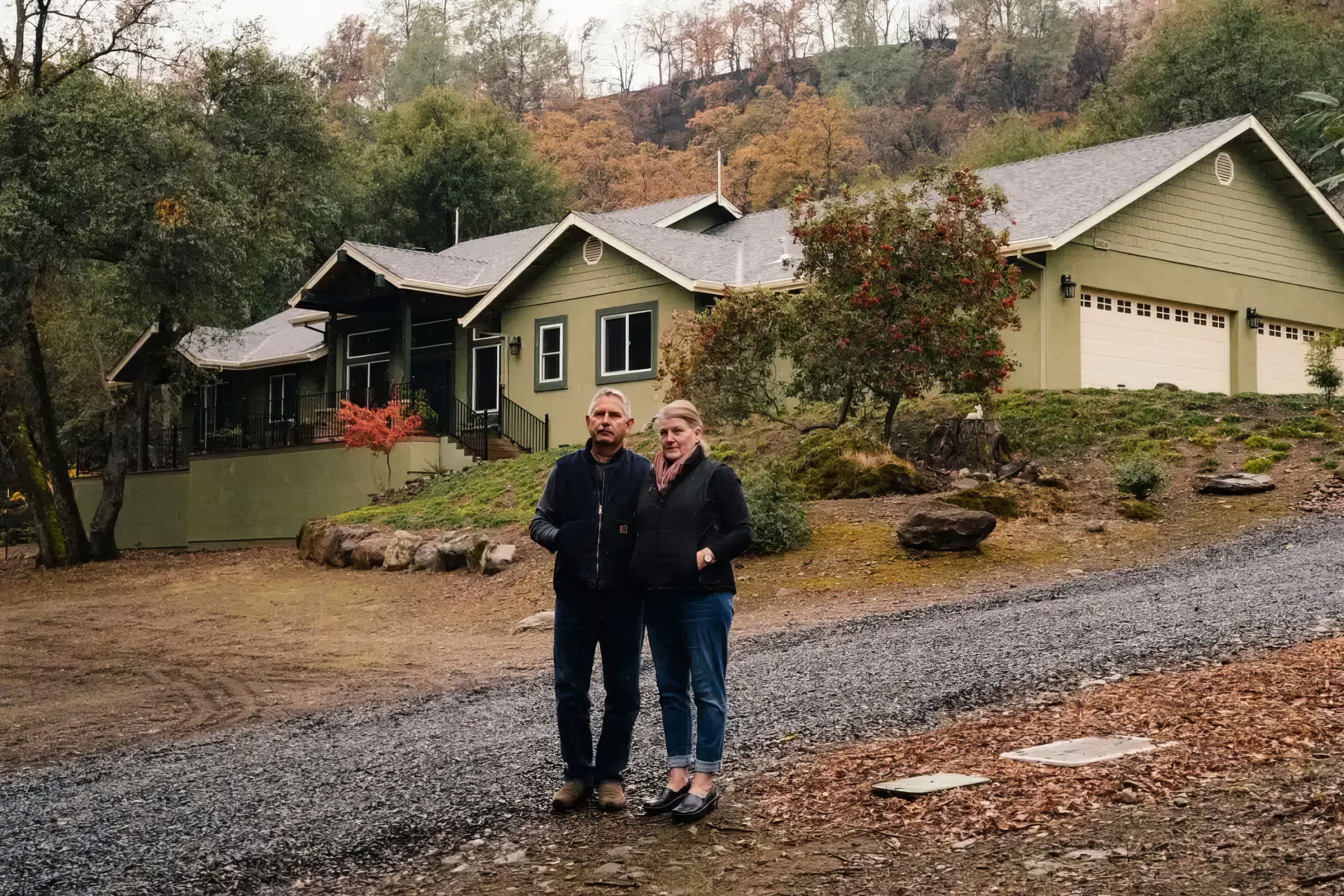 couple standing outside of home