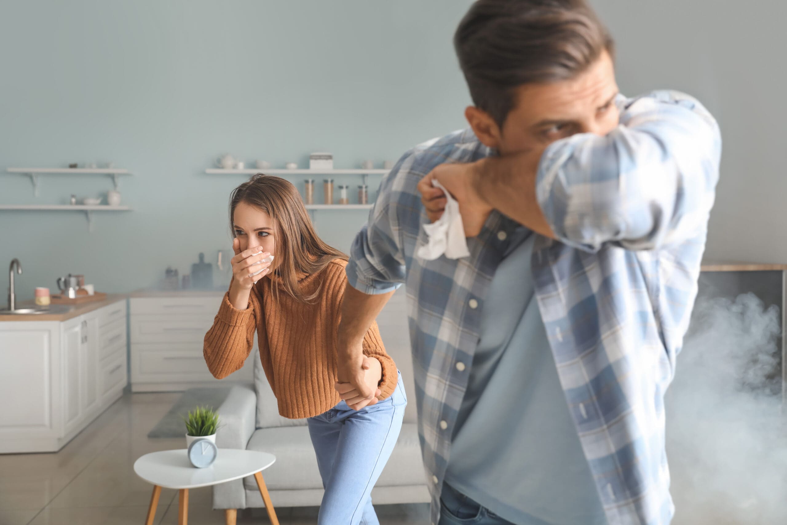 Young,Couple,Gasping,At,Home,Because,Of,Fire