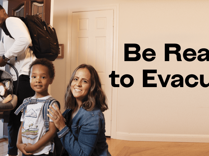 Family leaving home with baby in car seat and little boy with backpack. "Be Ready to Evacuate"